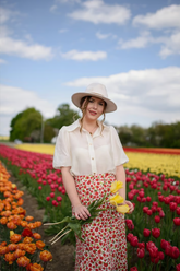 a lady wears a white shirt with a floral printed midi skirt